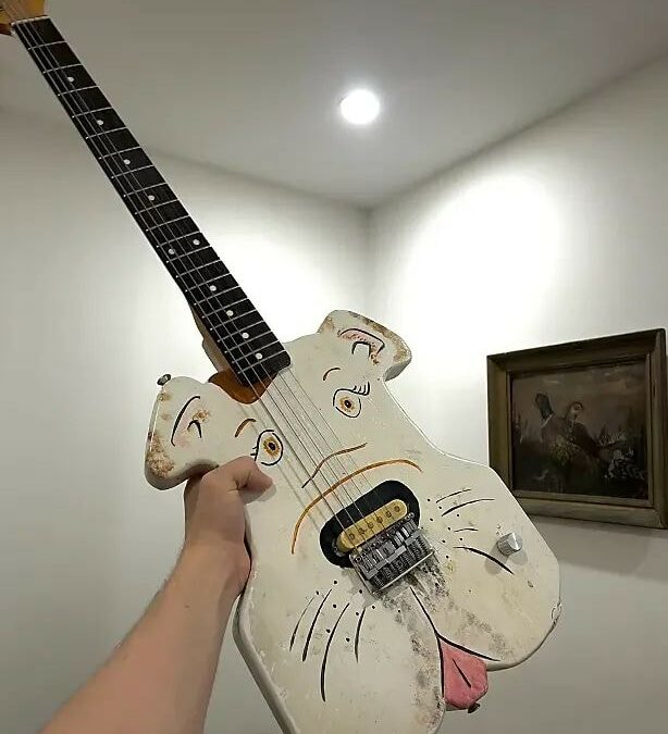 The Dog-Faced Stray Barking Up the Wrong Guitar