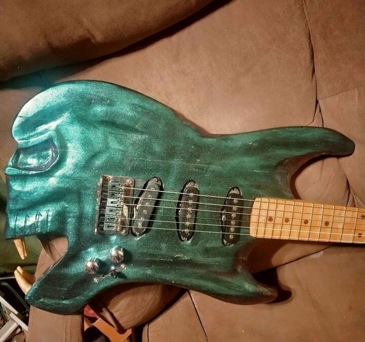 Strumming on the Wild Side on a Guitar with a Predator’s Smile!